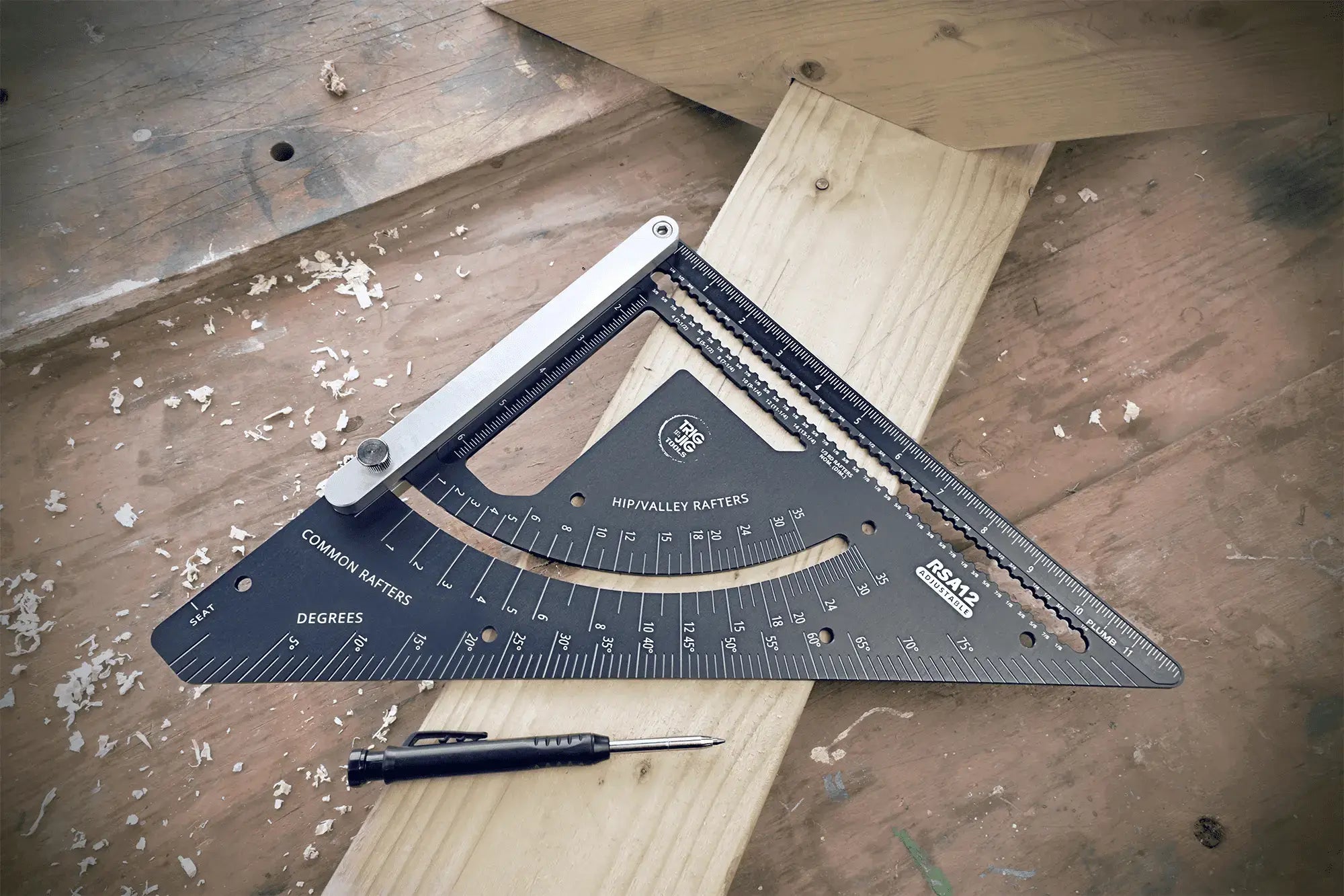 Rafter square tool on a wooden surface with a pen - RSA 12 Adjustable LE Rafter Square